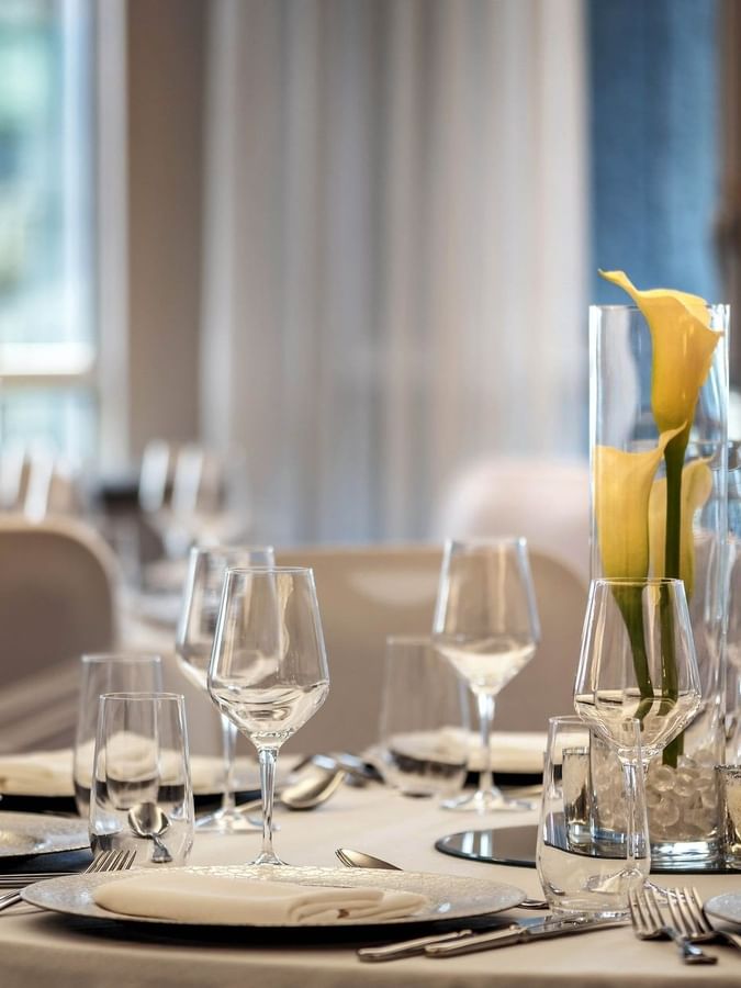 Elegantly set dining table with floral centerpiece in Ballroom at Warwick Le Crystal Montreal