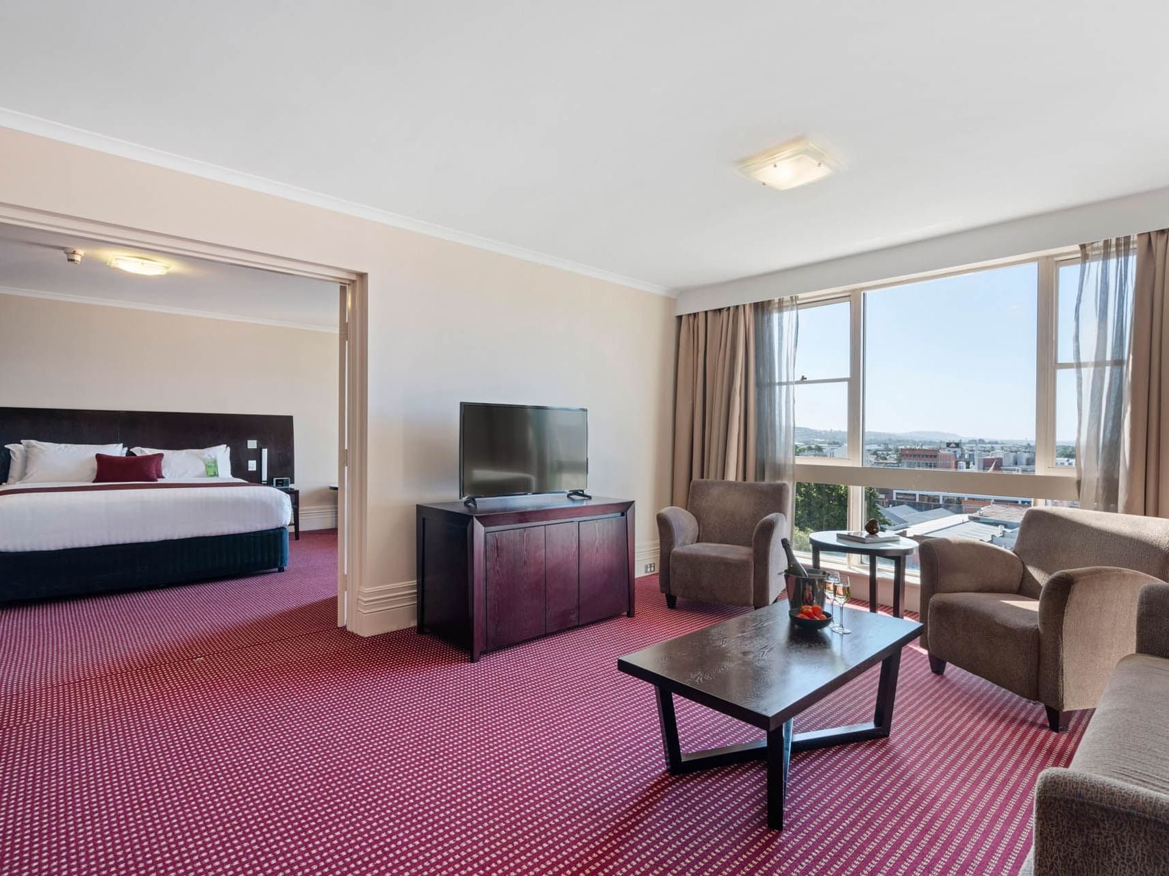 Living room with a city view in State Suite at Grand Chancellor Launceston