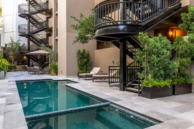 Outdoor pool area with the staircase at Dominion Suites Polanco