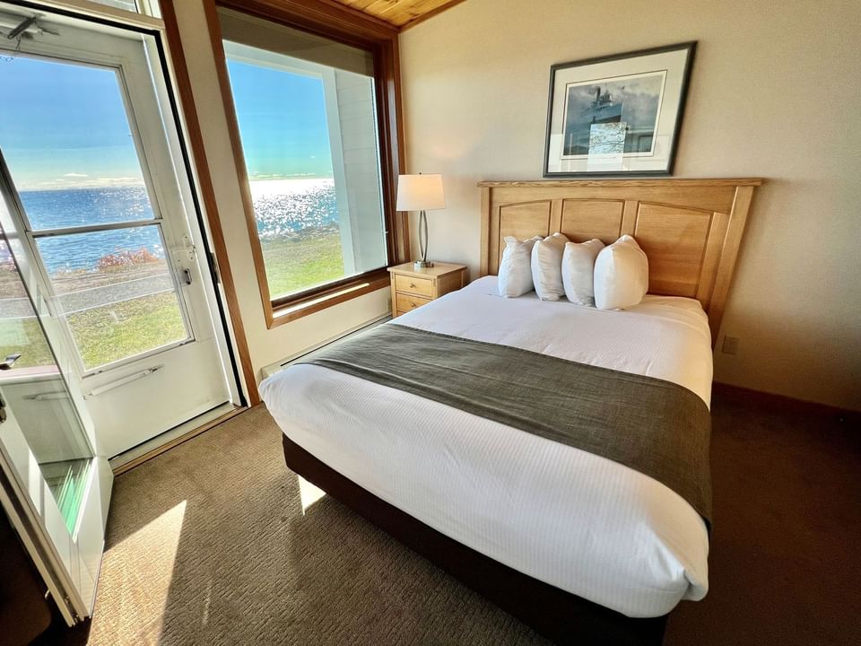 Queen bed in Dockside Guestroom, Bluefin Bay Family of Resorts