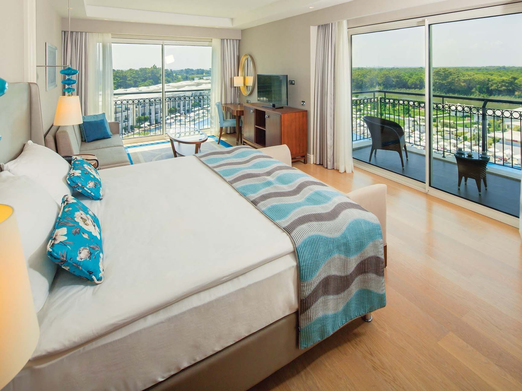 TV lounge area by the bed in Corner Suite with balcony view at Titanic Deluxe Golf Belek