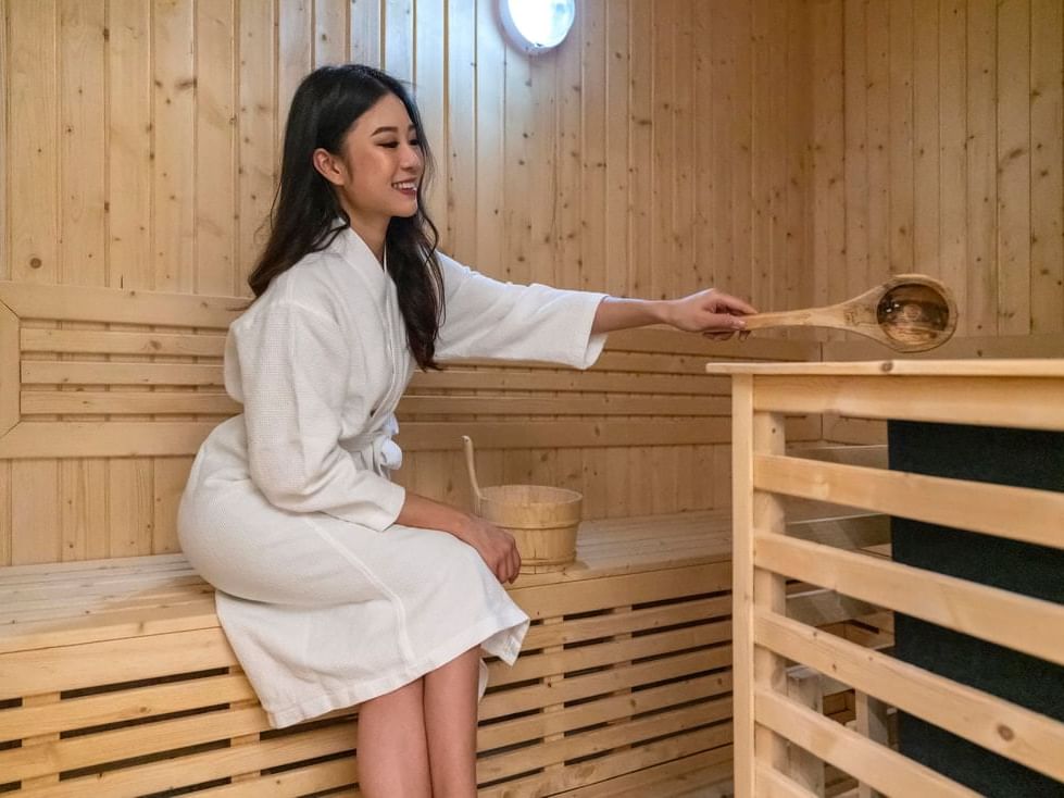 woman in white robe in sauna room
