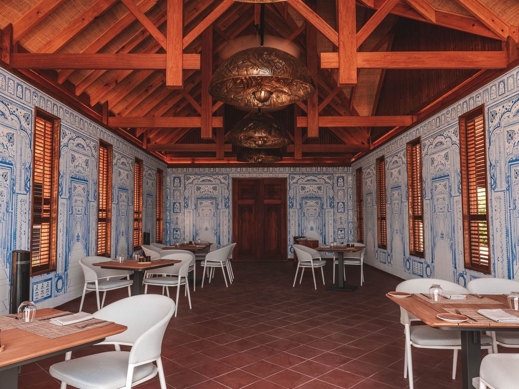 Dining and lounge area in Asian Food Street with a detailed wallpaper at Ananea Madivaru Maldives