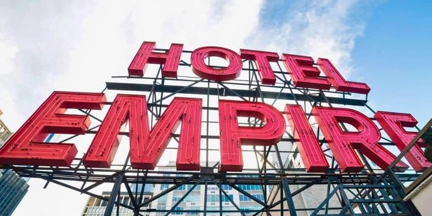 A red neon sign reading 'HOTEL EMPIRE'