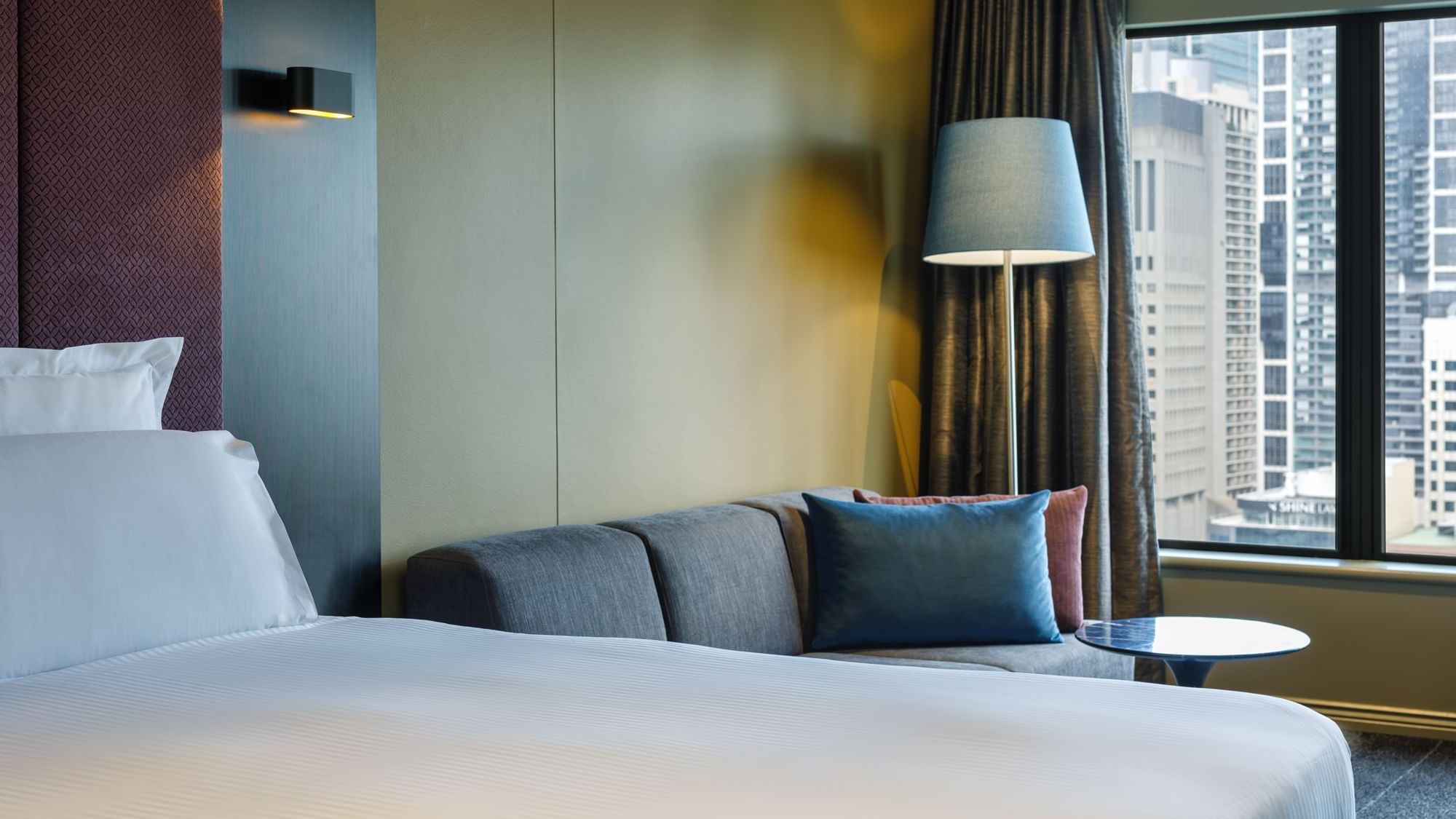 Lounge area by the comfy bed in Deluxe Room at Pullman Sydney Hyde Park