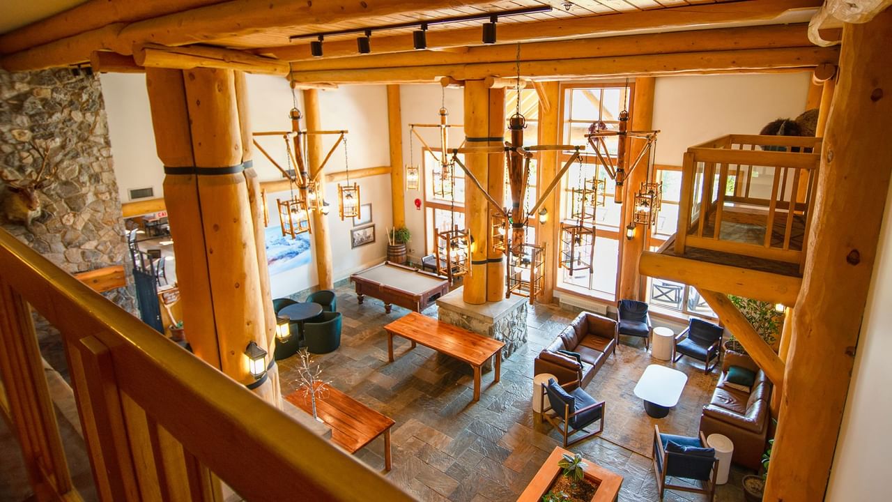 Lobby of Coast Hillcrest Hotel with couch, arm chair, and tables