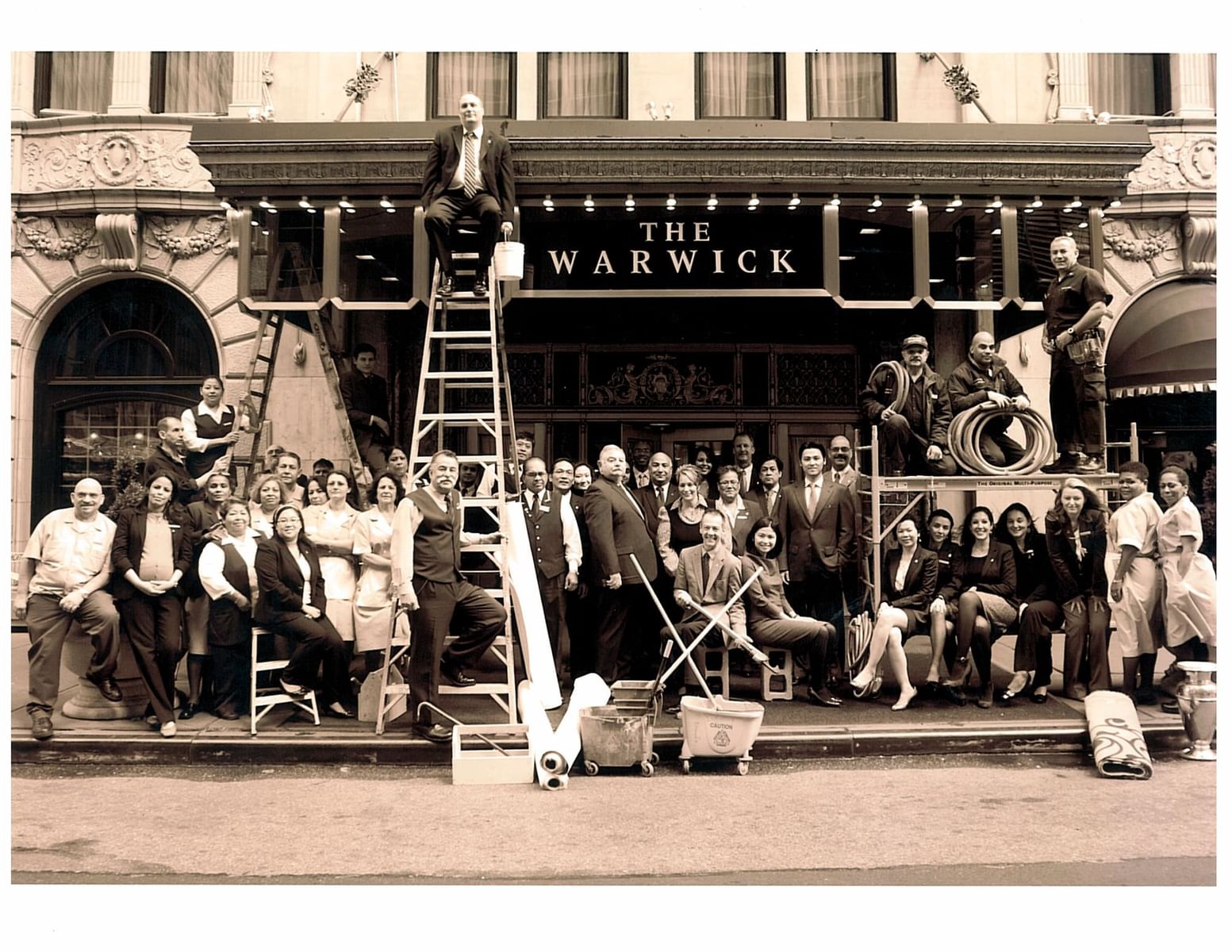 Diverse staff at The Warwick hotel with cleaning equipment, from Warwick Corporate
