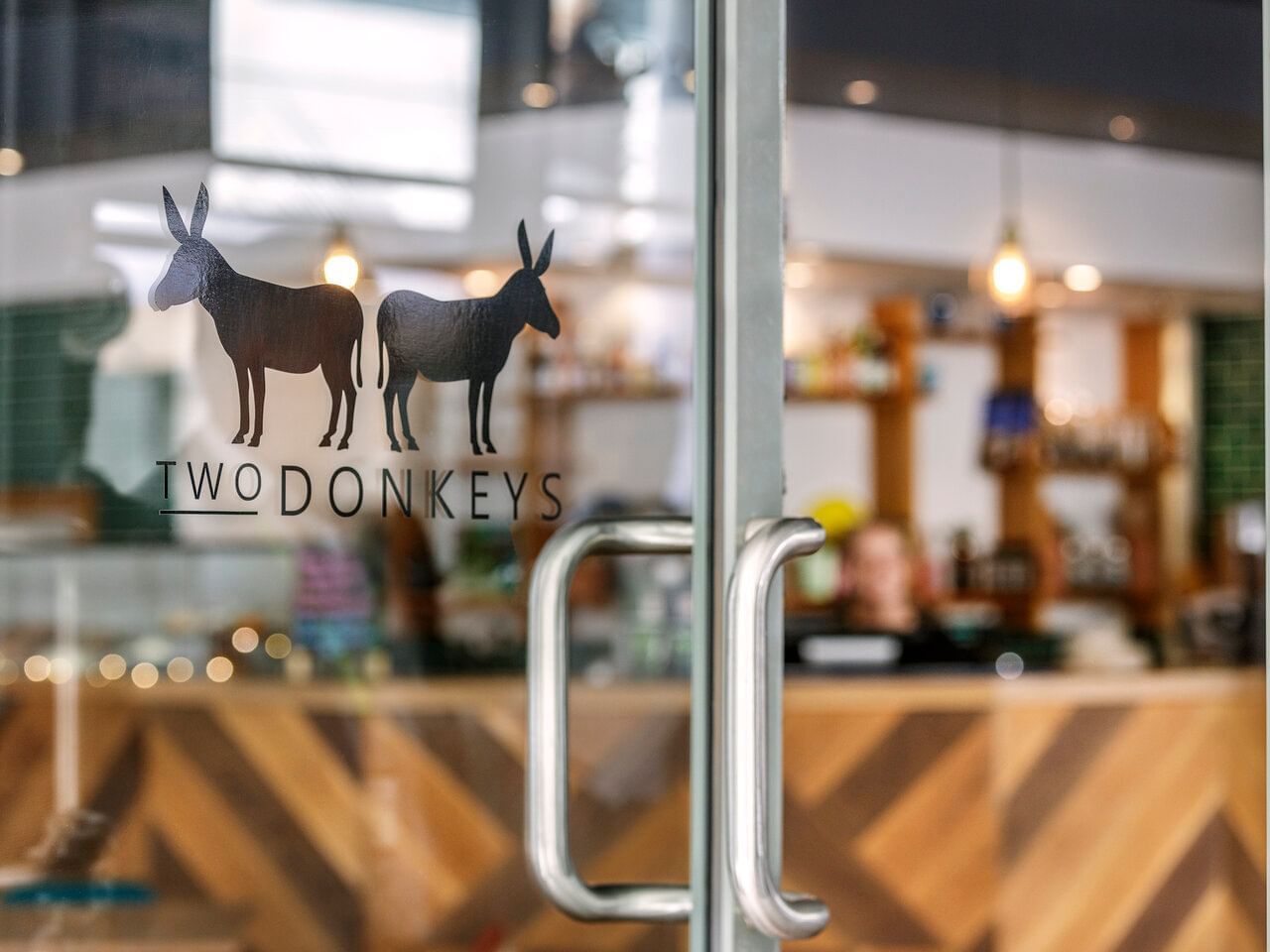 The entrance door of Two Donkeys Café at Amora Hotel Brisbane