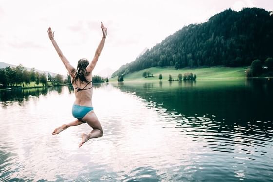 Woman jumps into the lake near Imlauer Schloss Hotel Piclarn