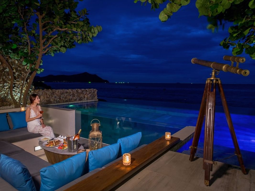 Lady with a drink relaxing in Beachfront Pool Villa at U Hotels