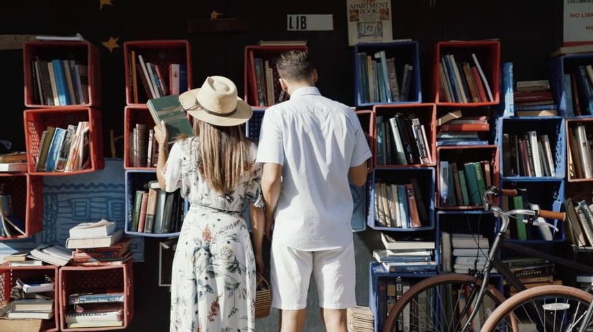 couple lookin through old books in outdoor store