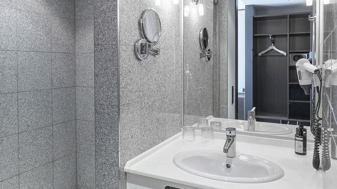 Bathroom vanity with sink and mirror in Classic Room at Titanic Comfort Kurfürstendamm