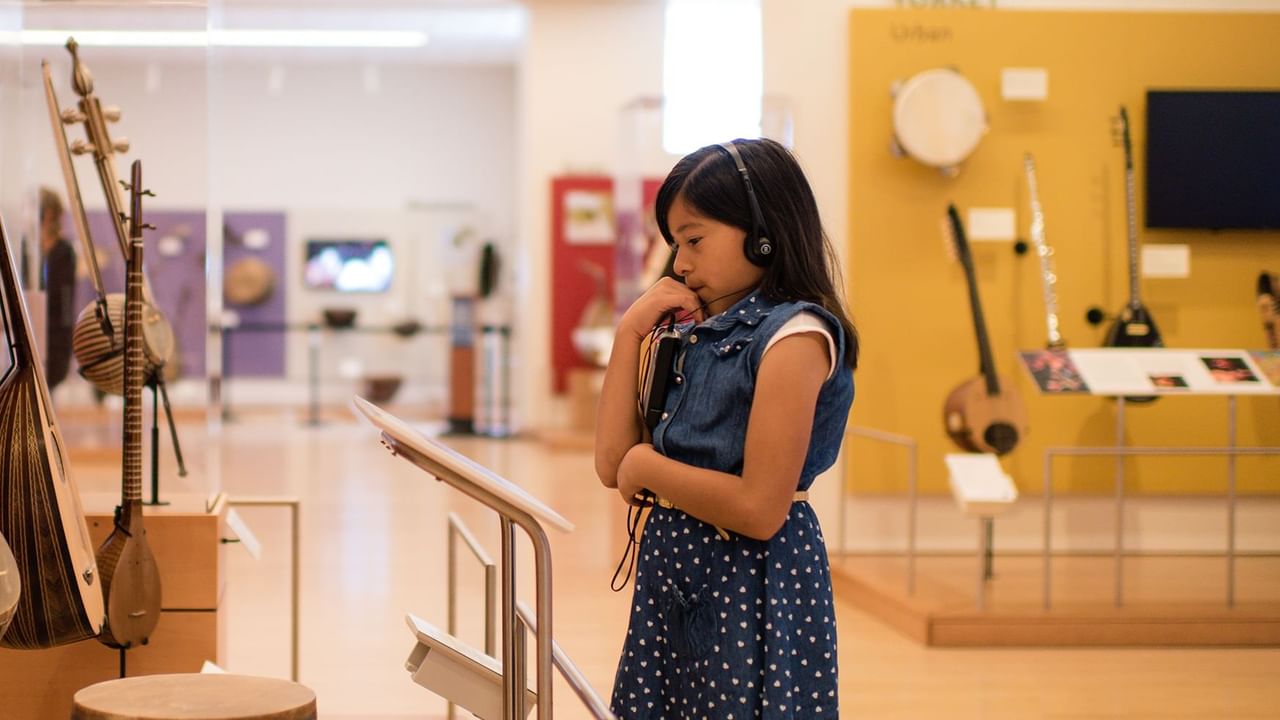 A girl in Dawson City Museum near Midnight Sun, a Coast Hotel