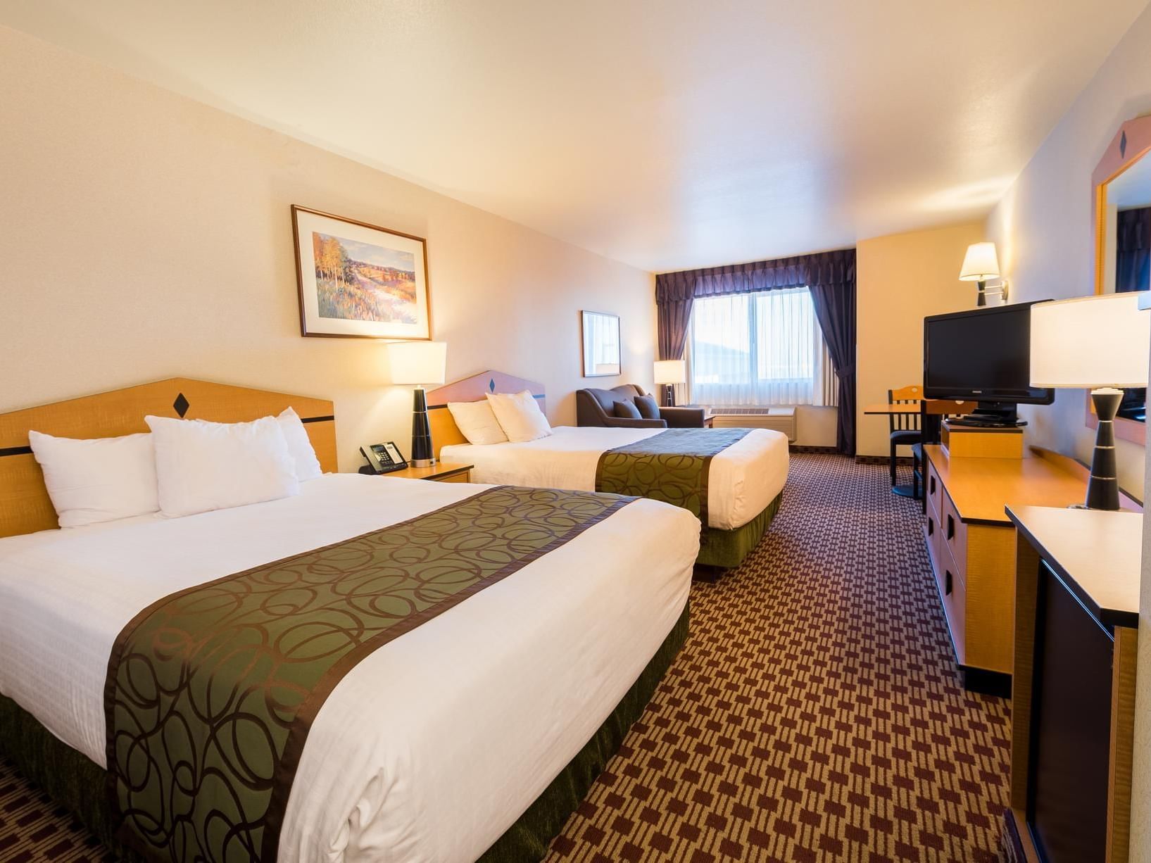 2 Comfy beds, TV and couch in Double Queen room at Crystal Inn Hotel & Suites