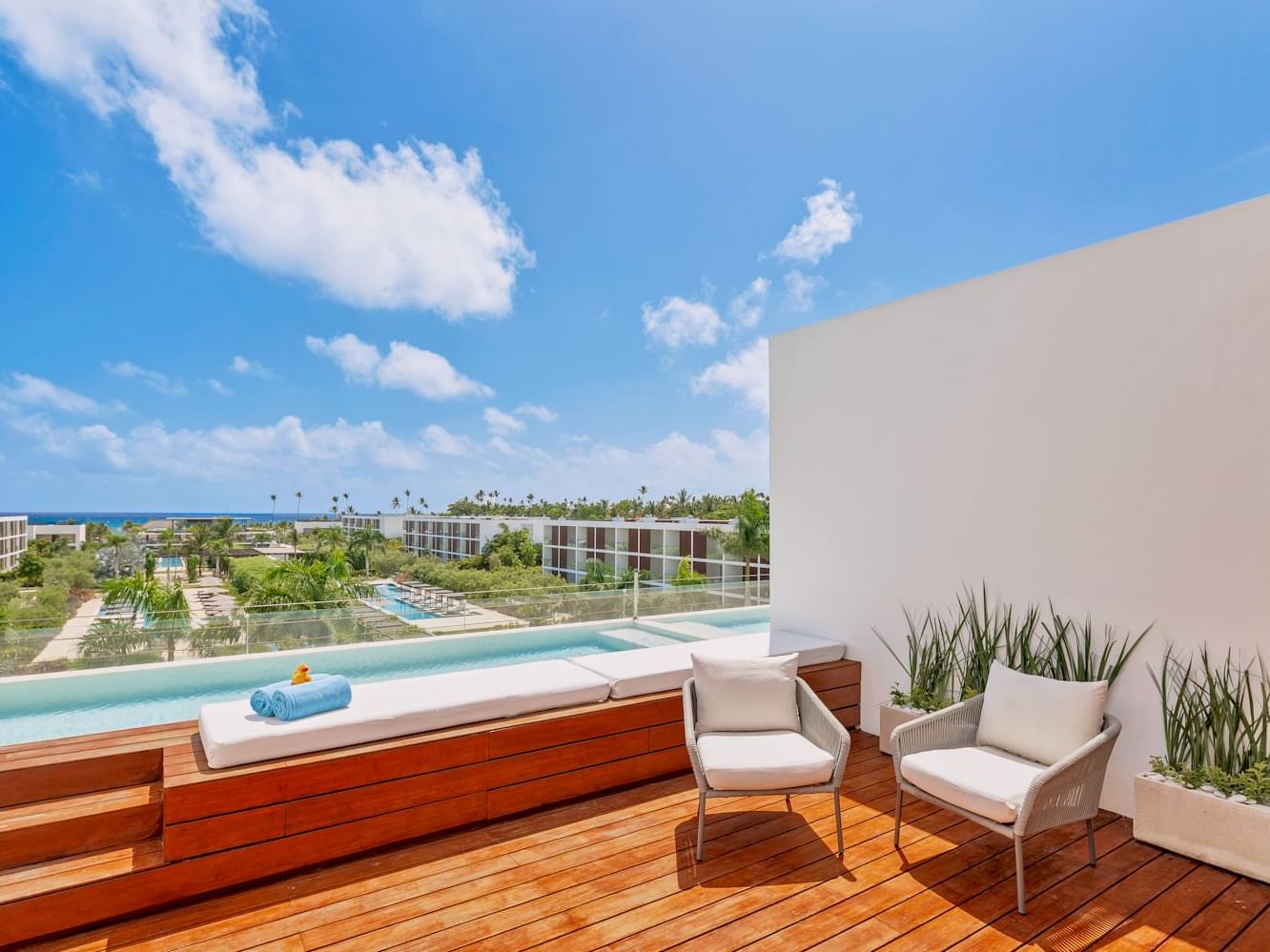 Loungers on the wooden floor by the pool in Fuego Suite at Live Aqua Punta Cana