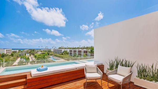 Loungers on the wooden floor by the pool in Fuego Suite at Live Aqua Punta Cana