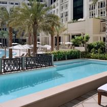 Outdoor pool with pool beds at Palazzo Versace Dubai
