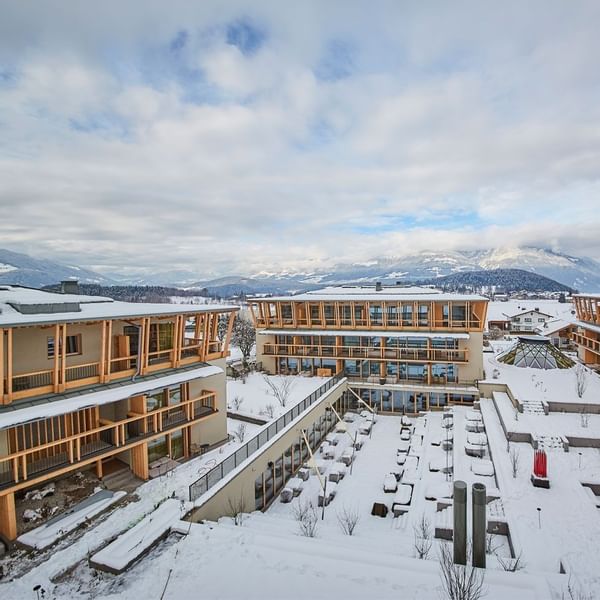 Aerial view of snow-covered Falkensteiner Hotel Kronplatz