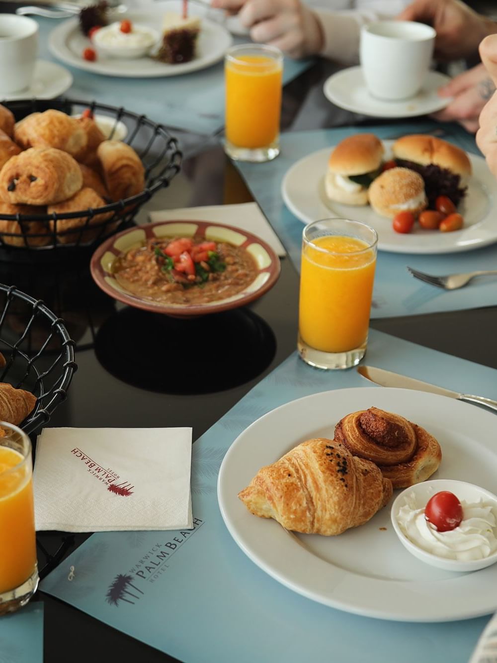 Croissants and Juices served on a table for breakfast in Palm Room at Warwick Palm Beach Hotel