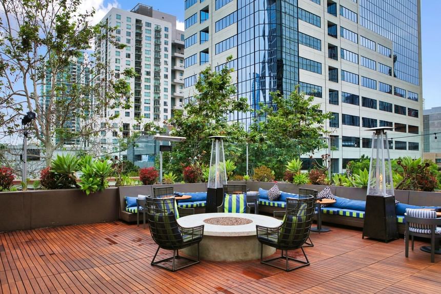 Open lounge area with a fireplace in Topside Terrace Kitchen & Bar at Hotel Republic San Diego