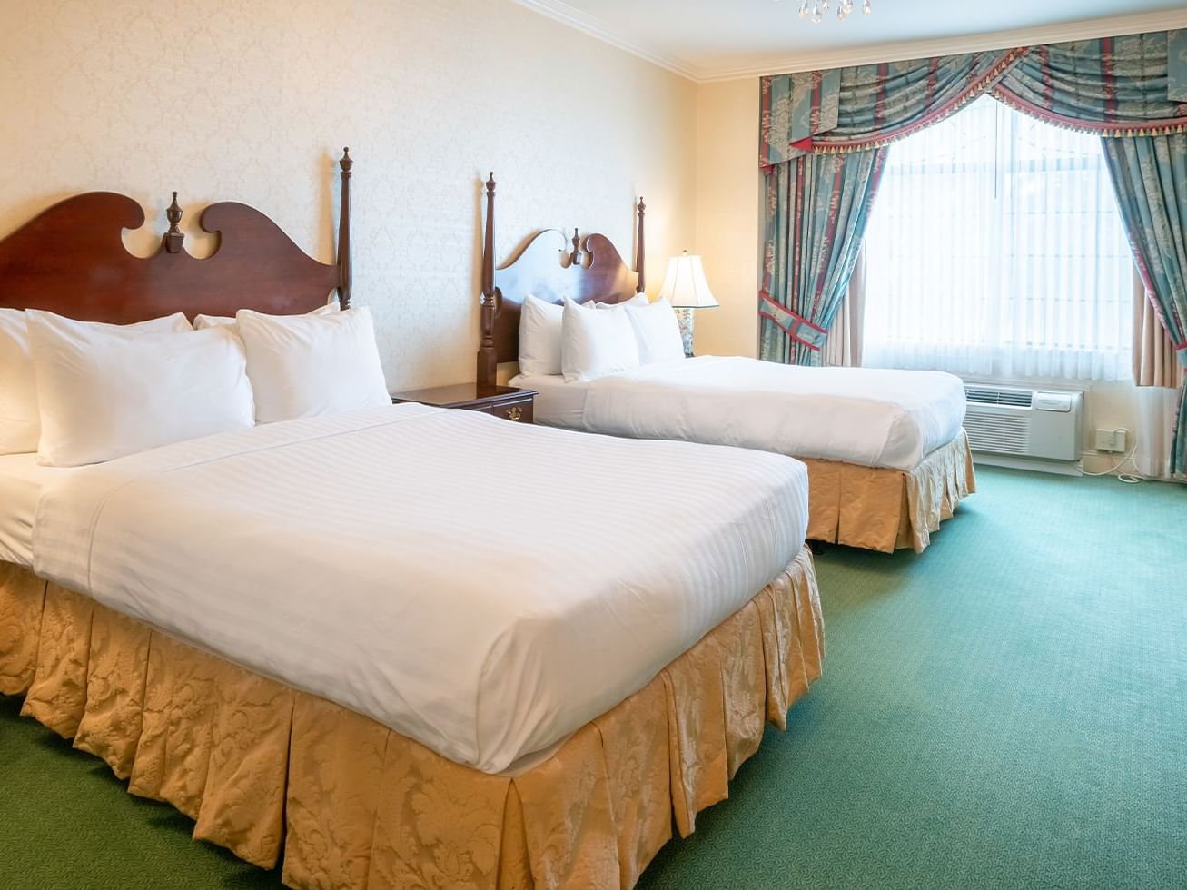 Bristol Hotel Double Suite with two vintage San Francisco beds and beautiful draped window