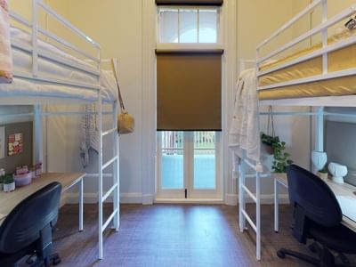Twin Loft room with two bunk beds and desks underneath at UniLodge Herston.