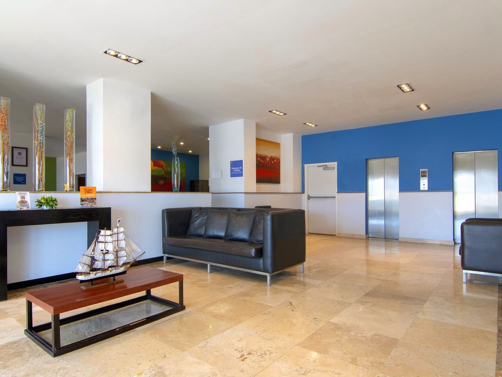 Lobby lounge area with a comfy sofa at One Hotels