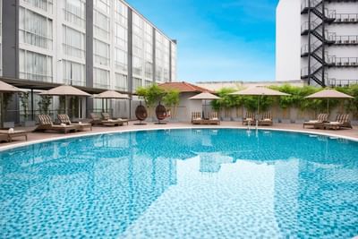 Outdoor swimming pool with pool beds at Eastin Grand Hotel Saigon