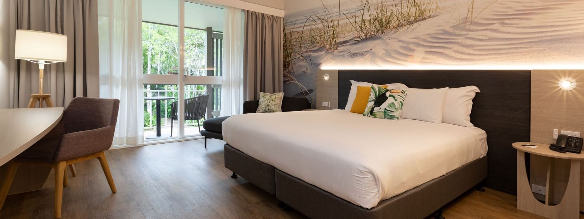 Classic room with king bed, coastal wall art, desk, balcony access at Novotel Sunshine Coast