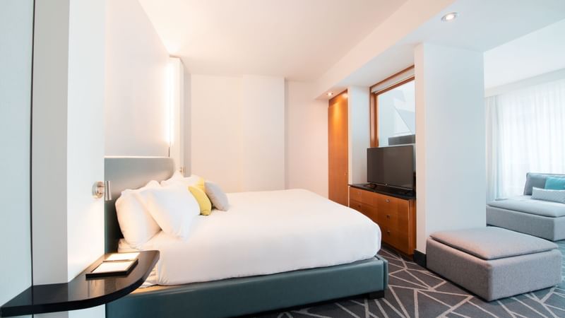 Modern bedroom with large bed in Premium loft Suite at Warwick Le Crystal