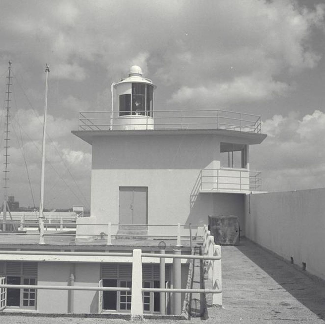 A grayscale photo of an old lighthouse near Fullerton Heritage Singapore