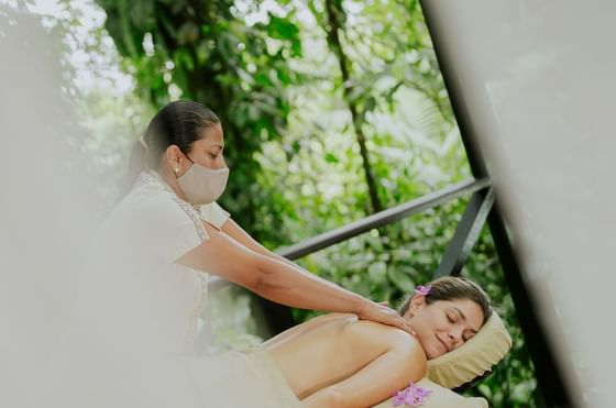 A girl enjoying a massage at the spa of Rio Celeste