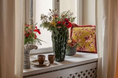 Tea cups & vases placed by a window at The Sparrow Hotel