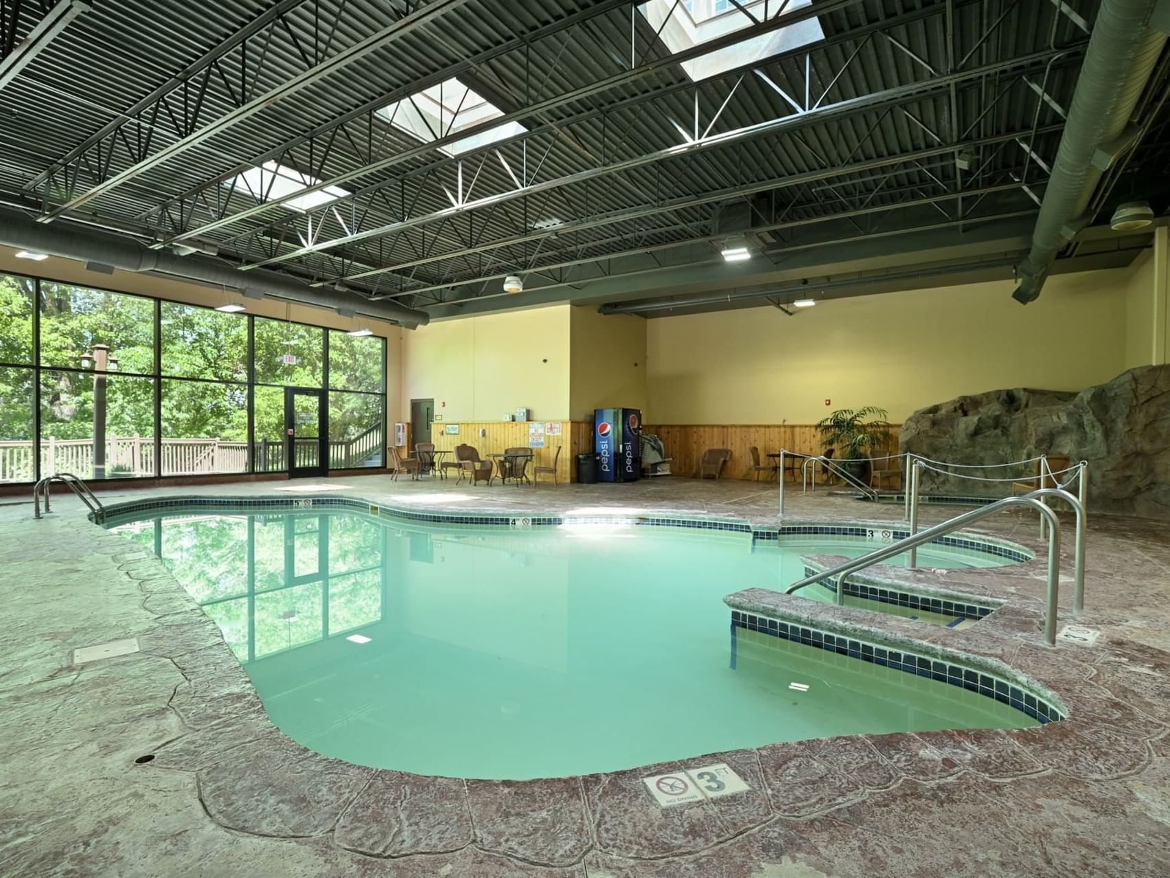 An indoor pool and lounge area at Chase on The Lake
