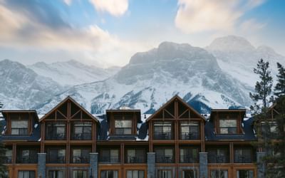 Exterior view of The Malcolm Hotel behind mountains