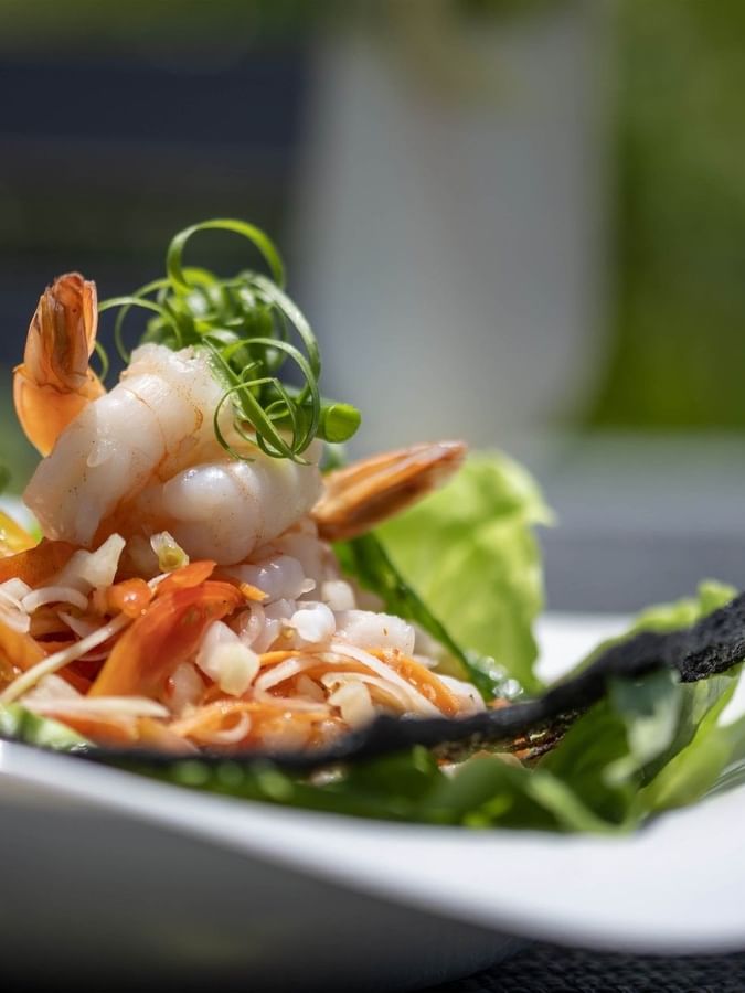 Fresh shrimp and vegetable salad served in a white bowl in Pool Grill & Bar restaurant at warwick le lagon-vanuatu