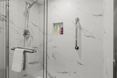 Bathroom shower with a marble design at Best Western Premier