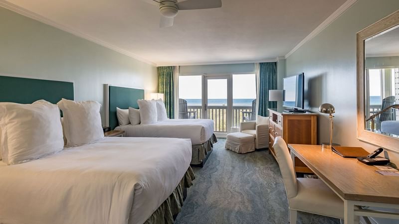 Twin beds & working desk in a guest room at WaterColor Inn