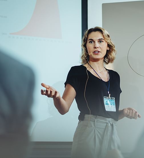 Woman presenting in a Coast Events Assured meeting