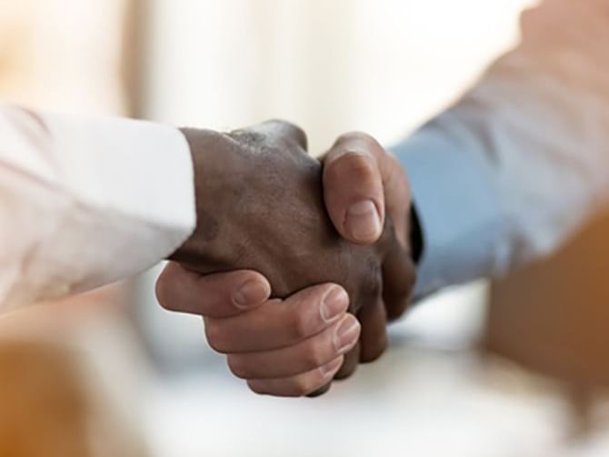 Close-up of 2 gentlemen shaking hands, Hotel Presidente Luanda