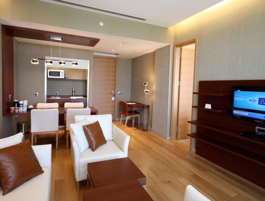 Modern interior with kitchenette, dining area and TV in Suite at Titanic Anadolu Gebze
