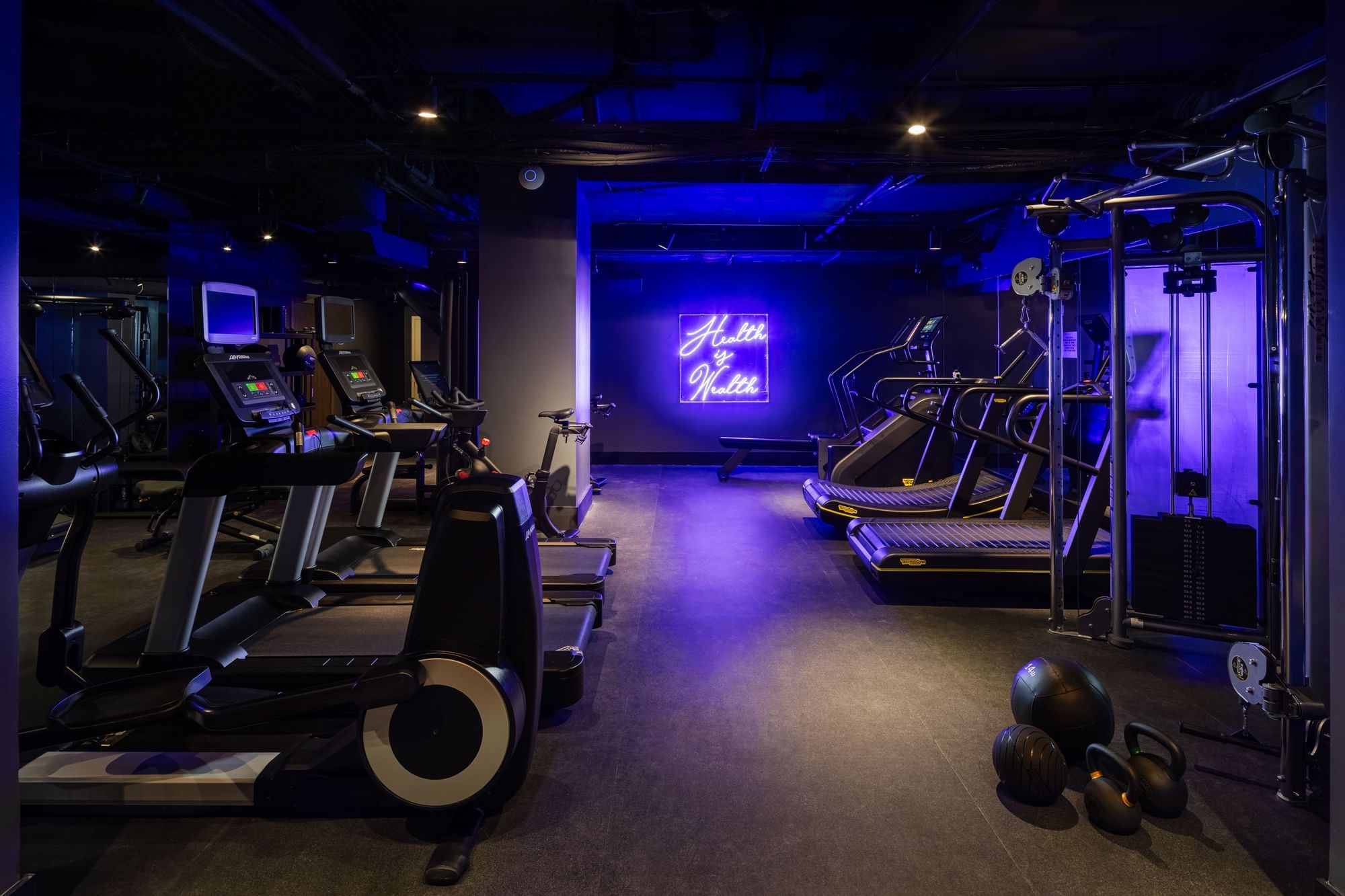 The Fitness Center with Peloton bikes, a Lululemon Studio Mirror, weights and treadmill