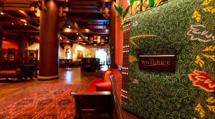 Entrance with the sign of Wild Rice restaurant in Serena Hotel