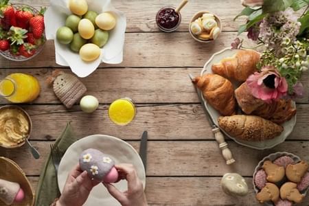 Colorful eggs, croissants & fruits on a Easter table at Warwick Brussels