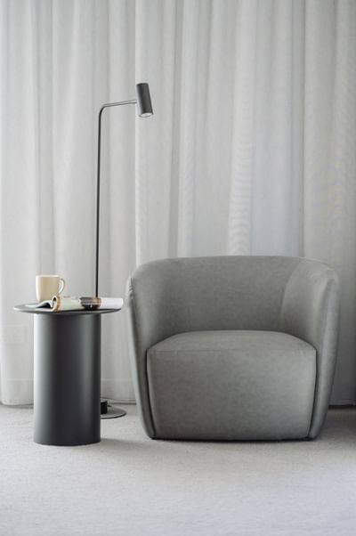 Floor lamp by a couch in a living area at Nesuto Docklands