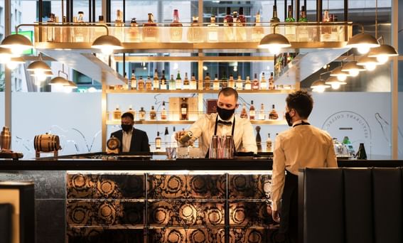 A bartender preparing a drink in the bar at ReStays Ottawa