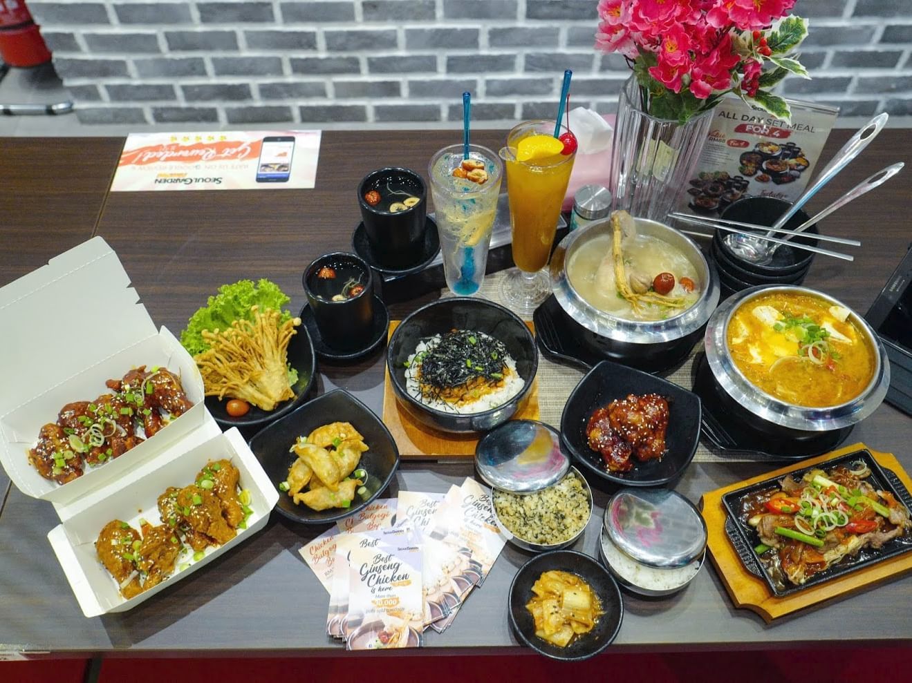 A table with Korean dishes, including soups, rice, fried chicken, and drinks served at Sunway Velocity Hotel