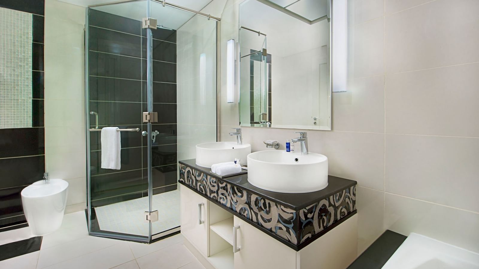 Bathroom vanity and shower area in Three Bedroom Suite at DAMAC  Maison Dubai Mall Street