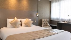 Comfy king bed with white & gold bedding in Originals Hotels