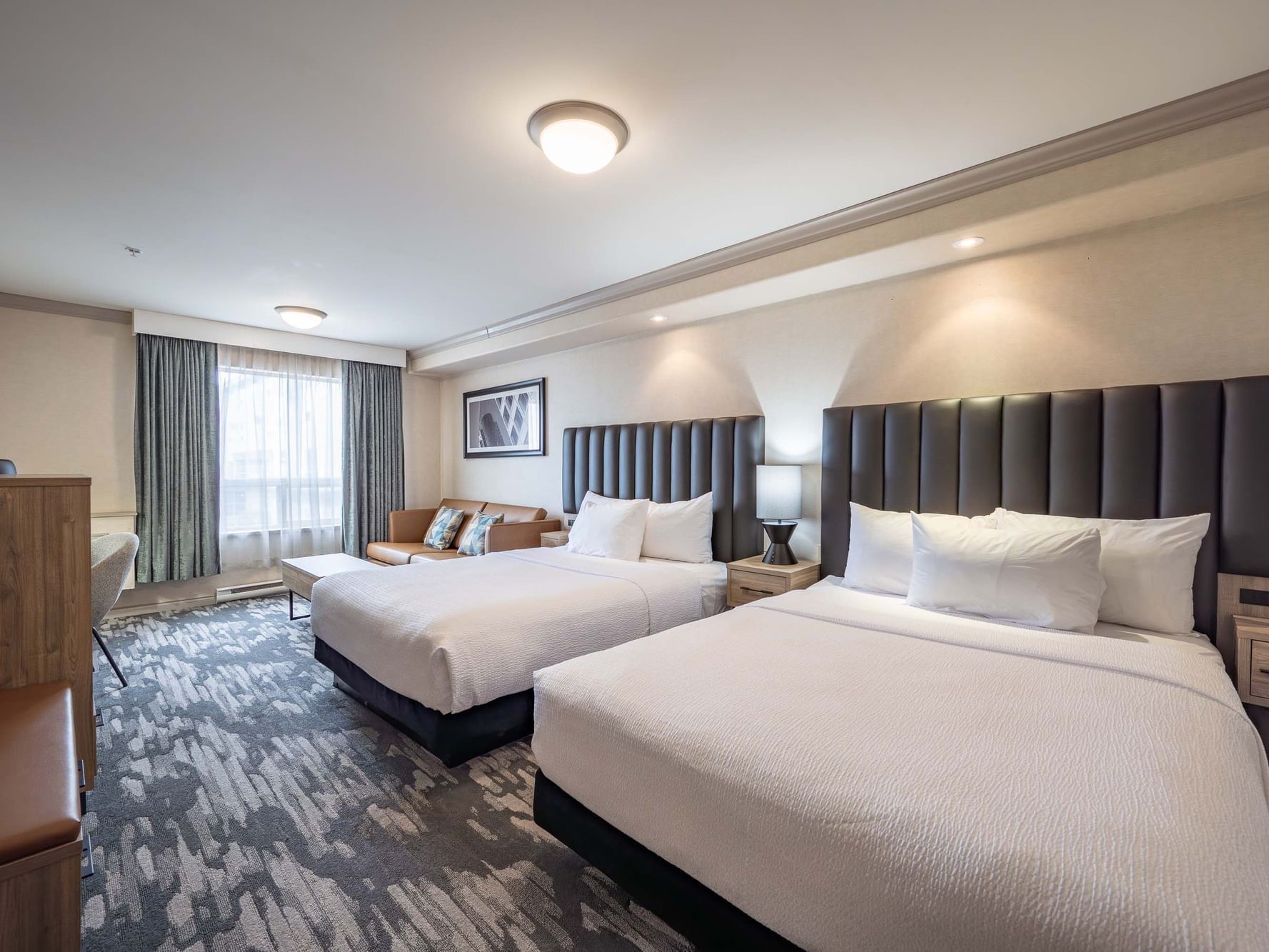 Two beds with nightstands in the Standard Room at Sandman Hotel & Suites Winnipeg Airport